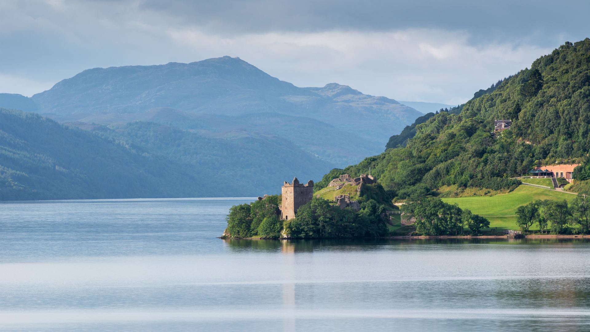 Urquhart Castle overlooking the calm, blue Loch Ness