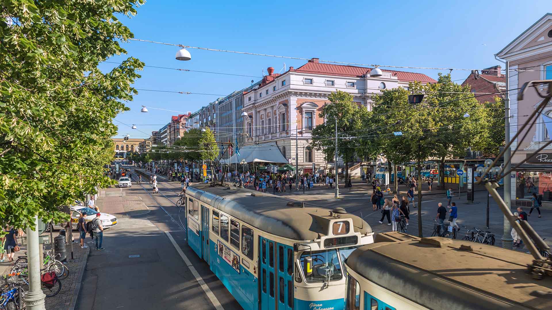 Tram and locals on popular Avenyn street in Gothenburg