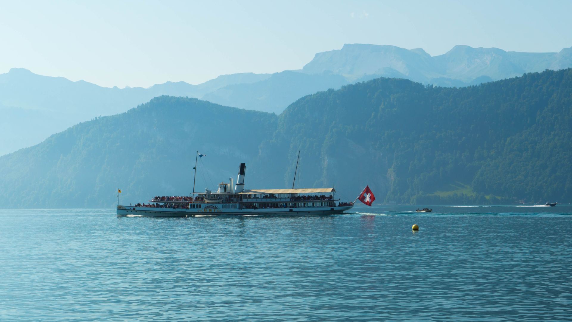 A vintage paddle steamer boat on lake lucerne