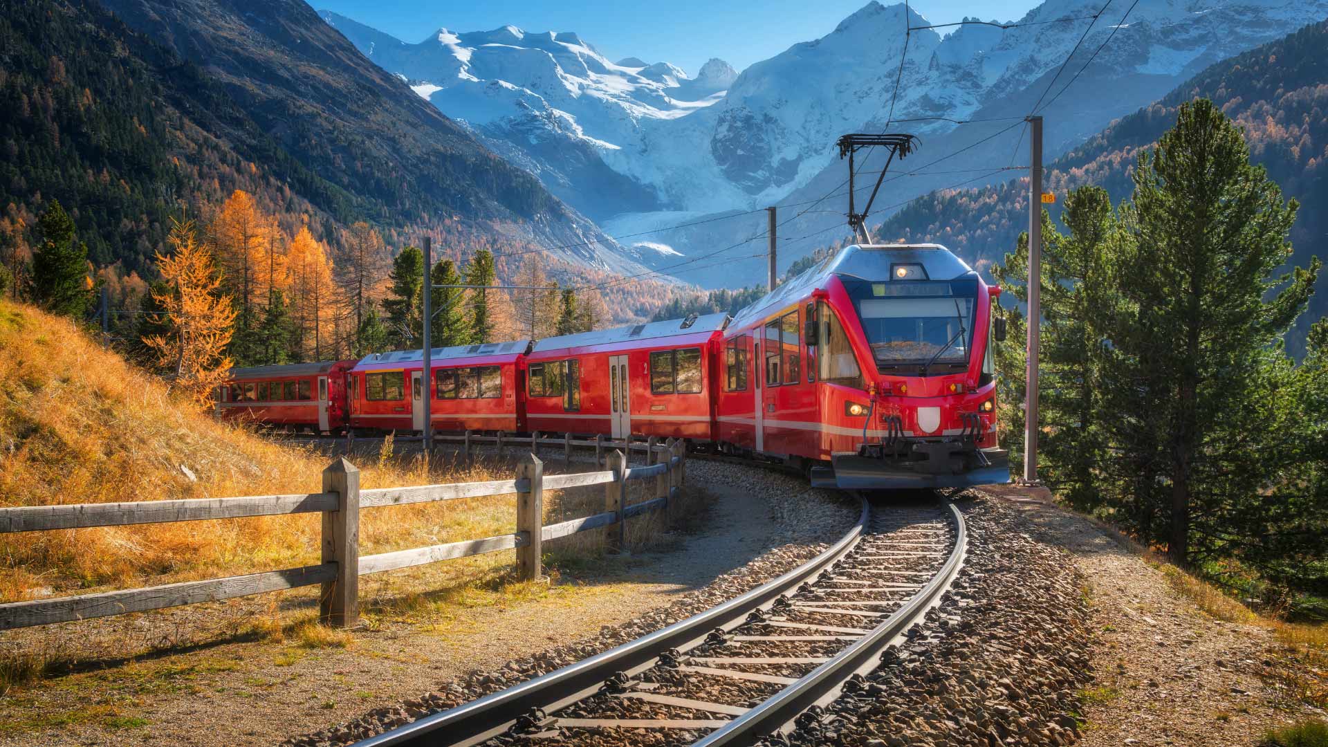 Red Bernina Express on railway through Swiss mountains