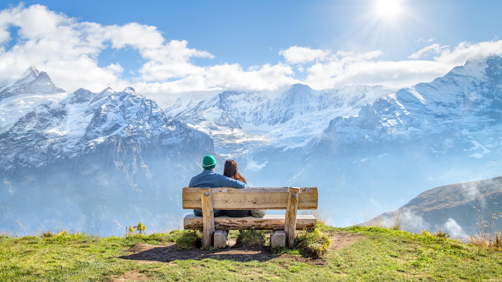 Couple sitting on a bench in the Swiss Alps