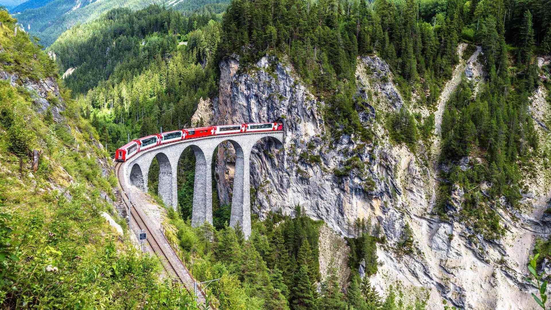 Glacier Express train going over a bridge in the Swiss Alps