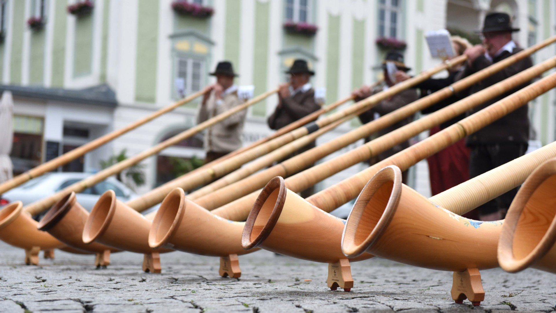 Group of people playing alphorns in the Alps