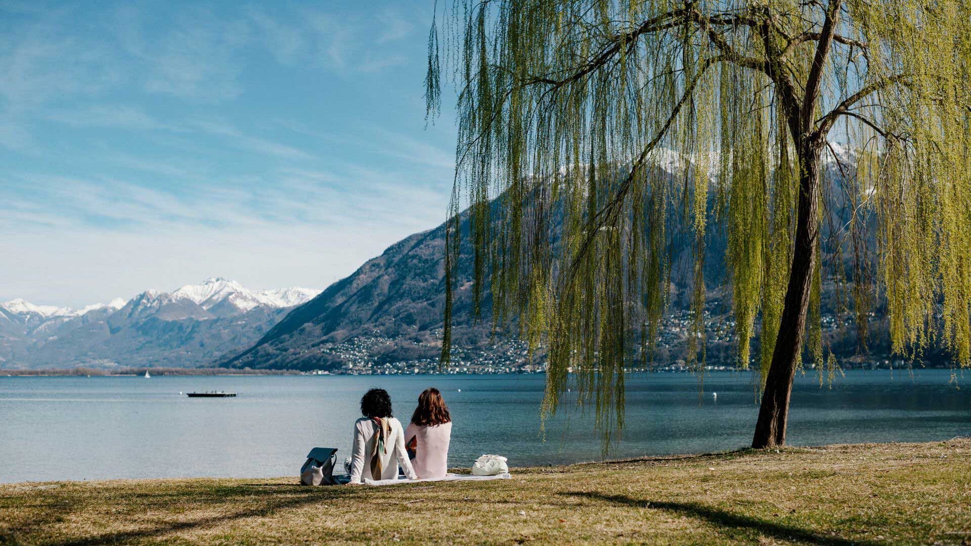 People having a picnic on the lakeshore at Lorcarno, Switzerland