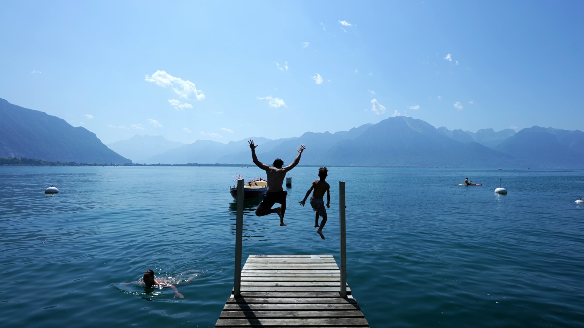 People jumping into a Swiss lake