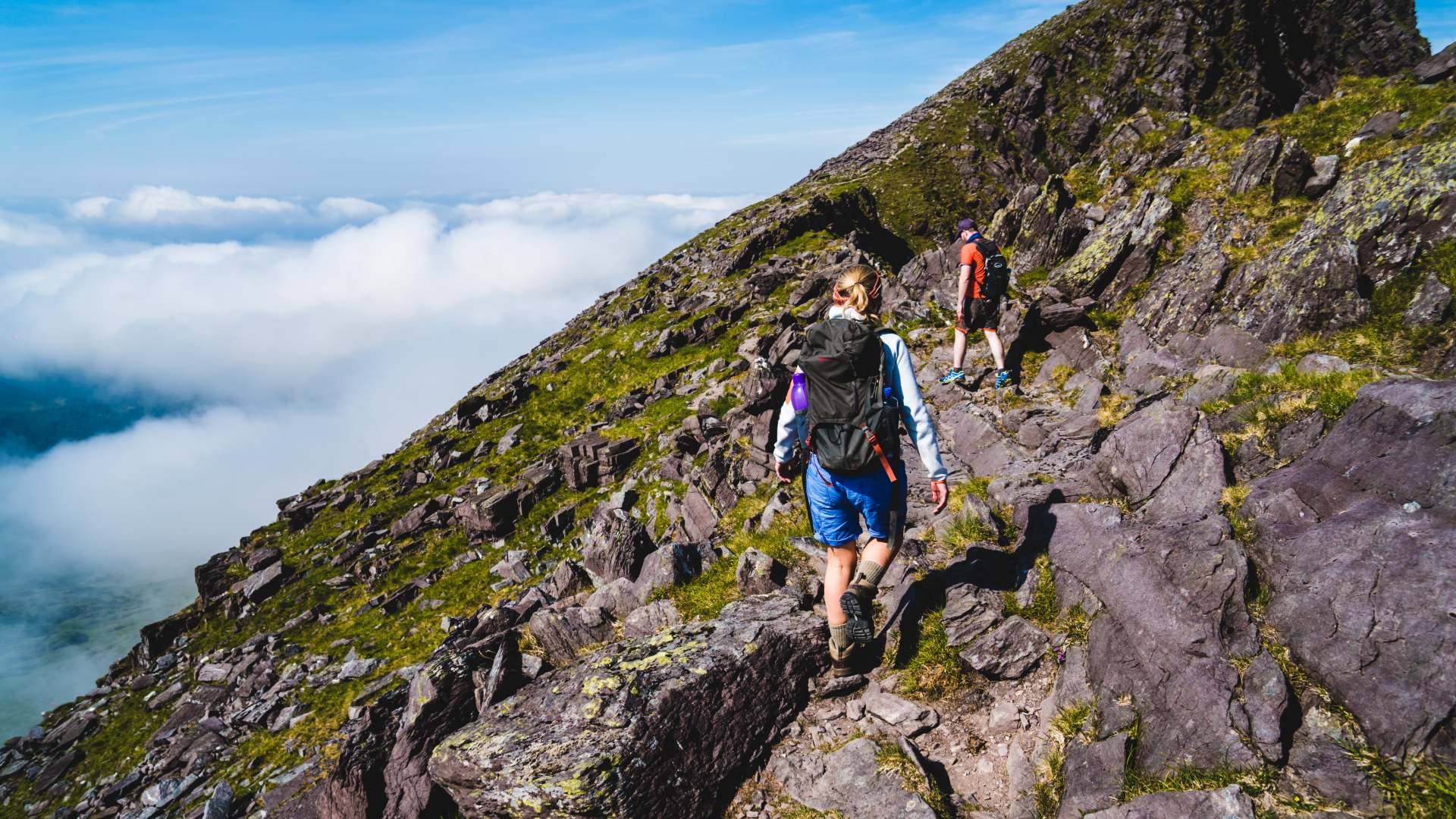 Man and woman hiking towards Mount Carrauntoohil in Killarney National Park