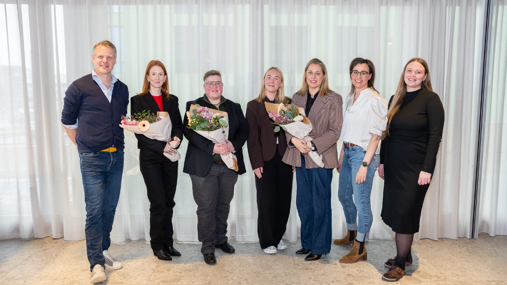 Representatives of UN Women, Einstök börn, and Neistinn pose at Travel Connect Fund event with flowers