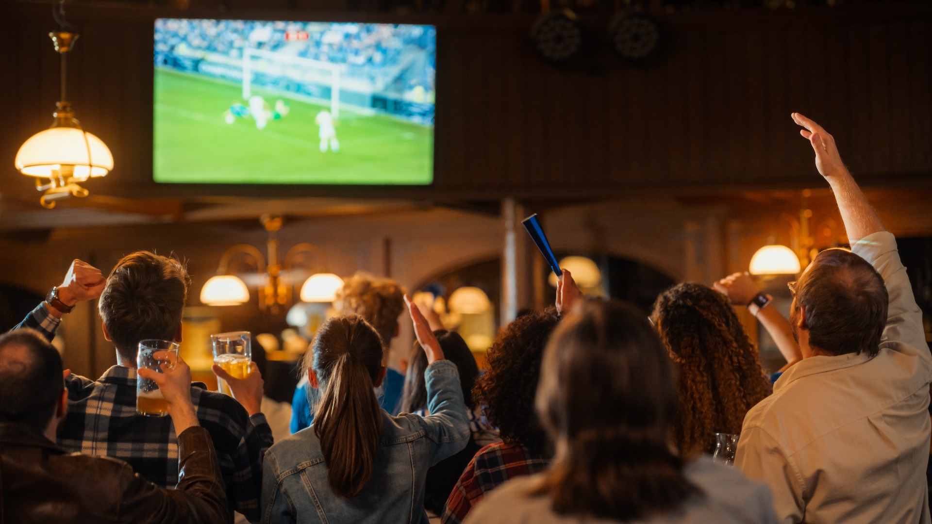 people watching football in a British pub
