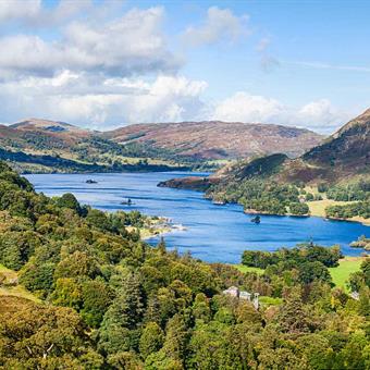 ullswater from above with green forests surroundings deep blue lake