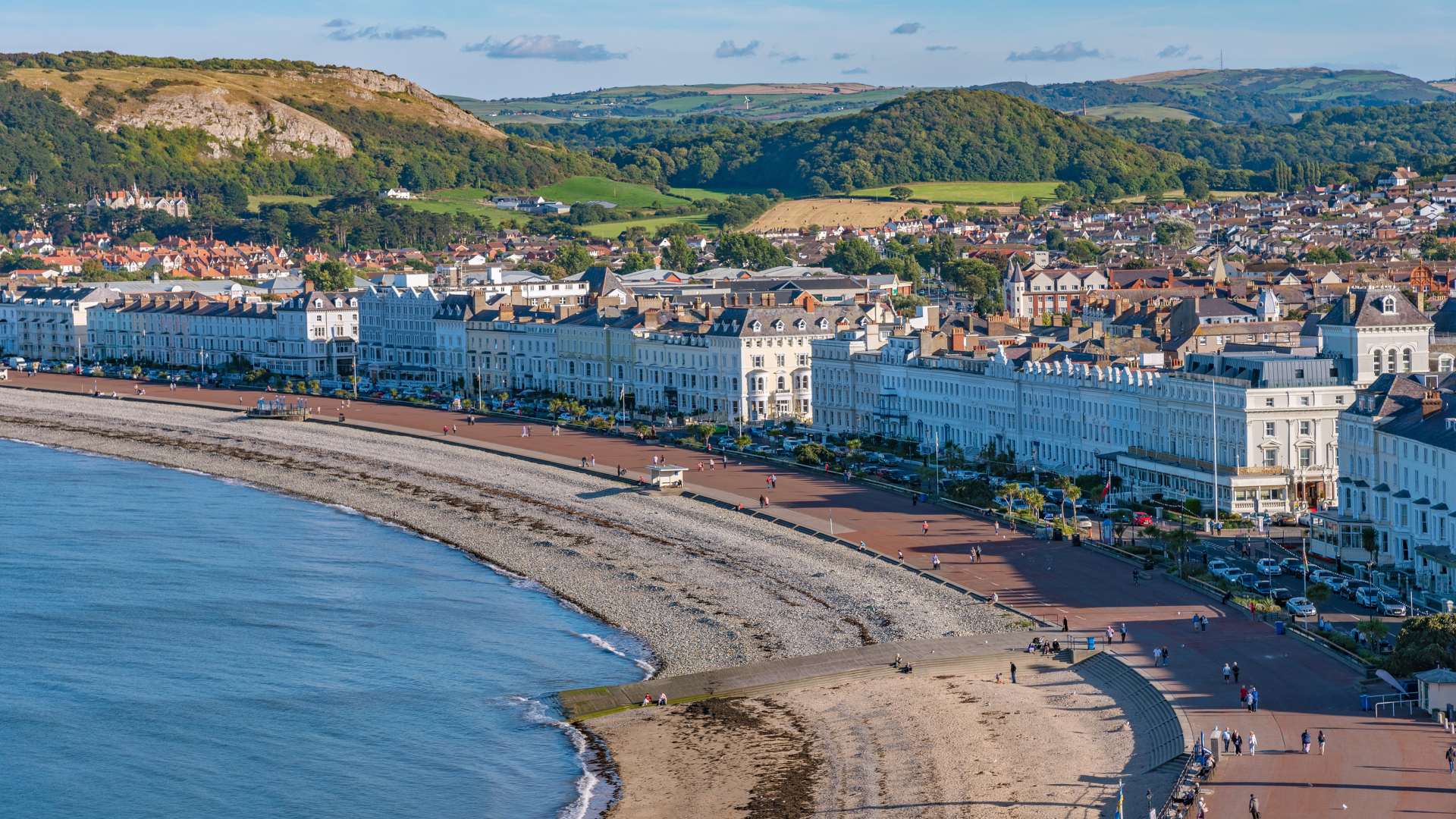 view of Llandudno seaside town and beach with rolling green hills behind