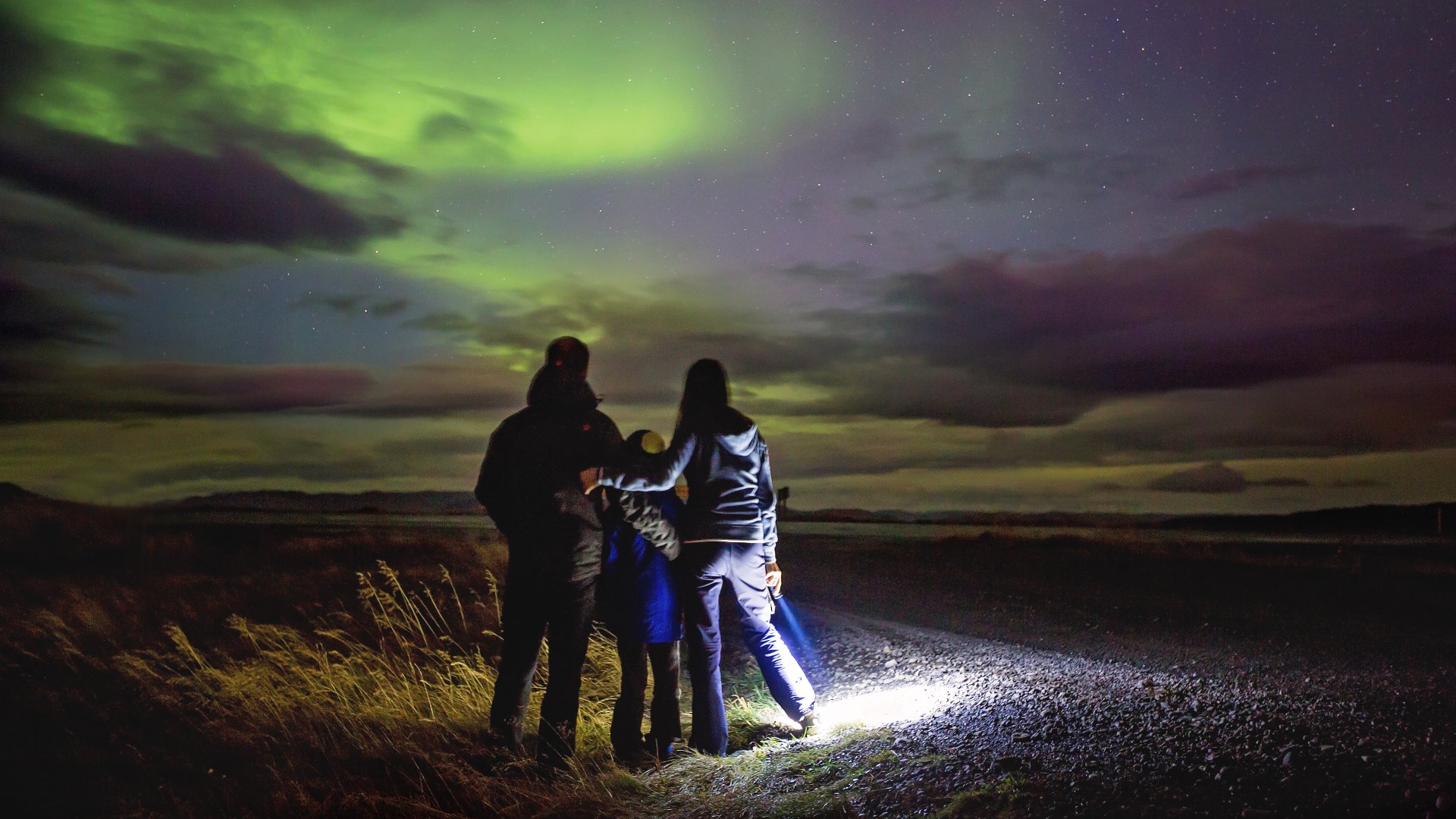 family watching the northern lights iceland