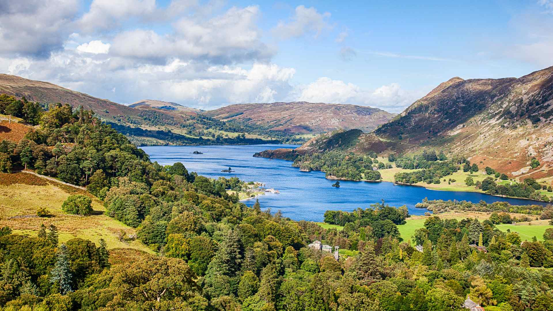 ullswater from above with green forests surroundings deep blue lake